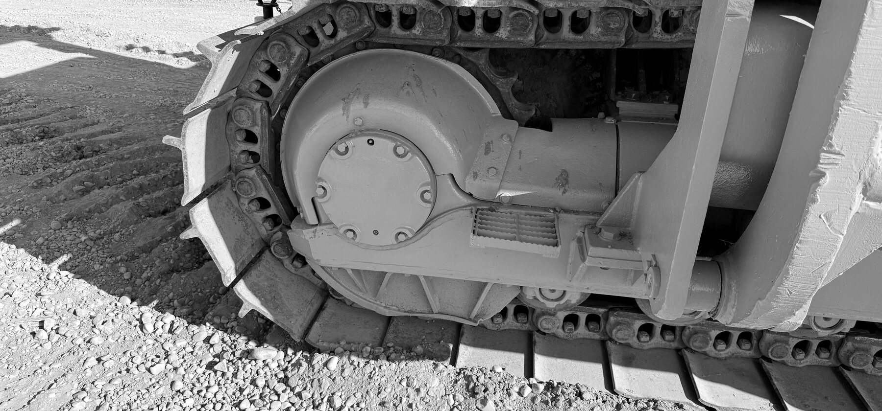 A final drive sprocket and track chain on a pipelayer undercarriage