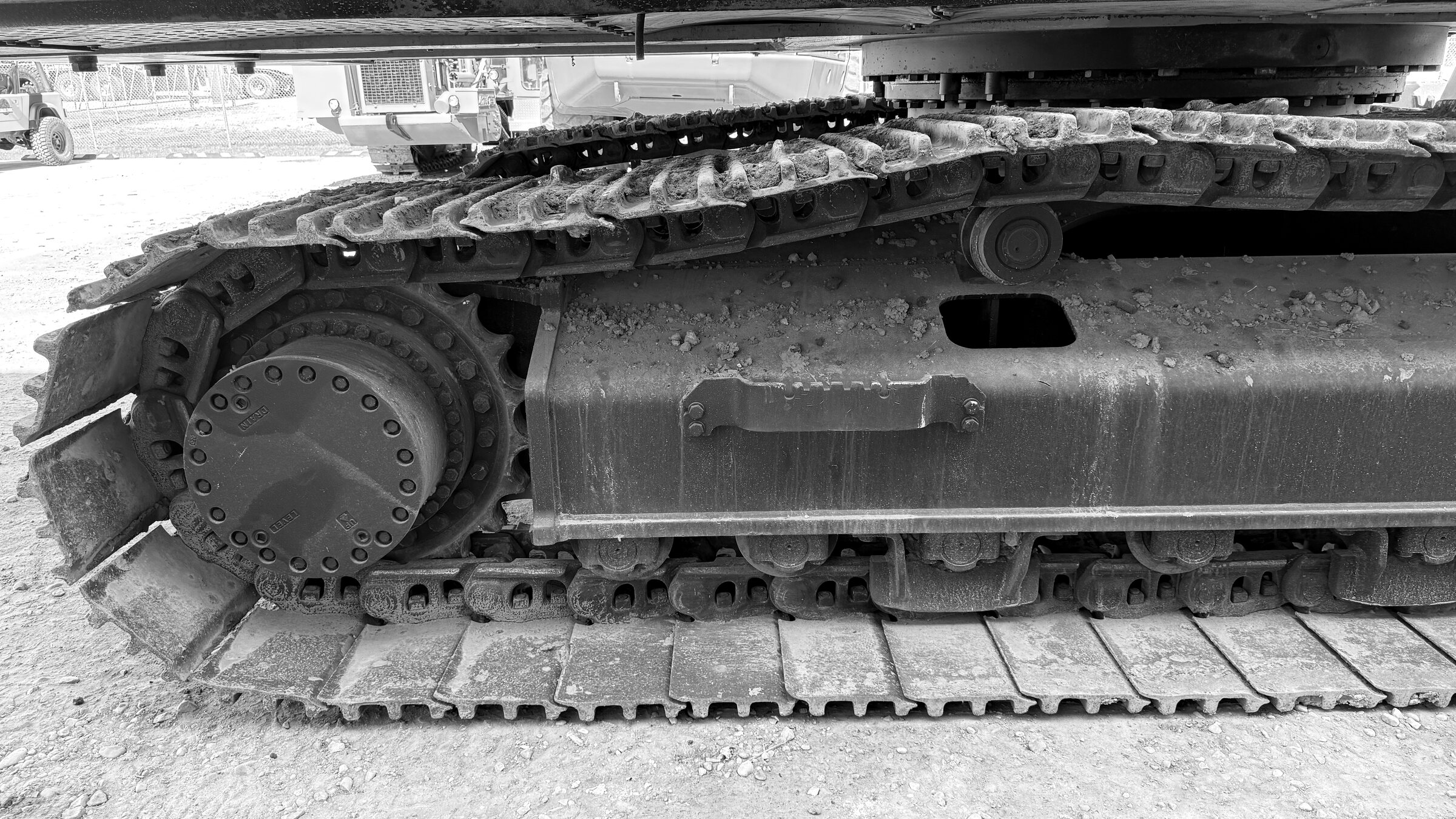 The undercarriage of a tracked excavator: the drive sprocket, track chain and rollers